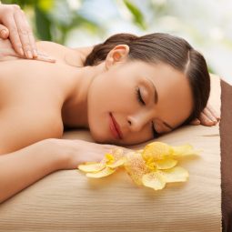 beauty, holidays and spa concept - woman in spa salon getting massage