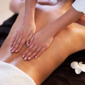 Relaxed smiling woman receiving a back massage in a spa